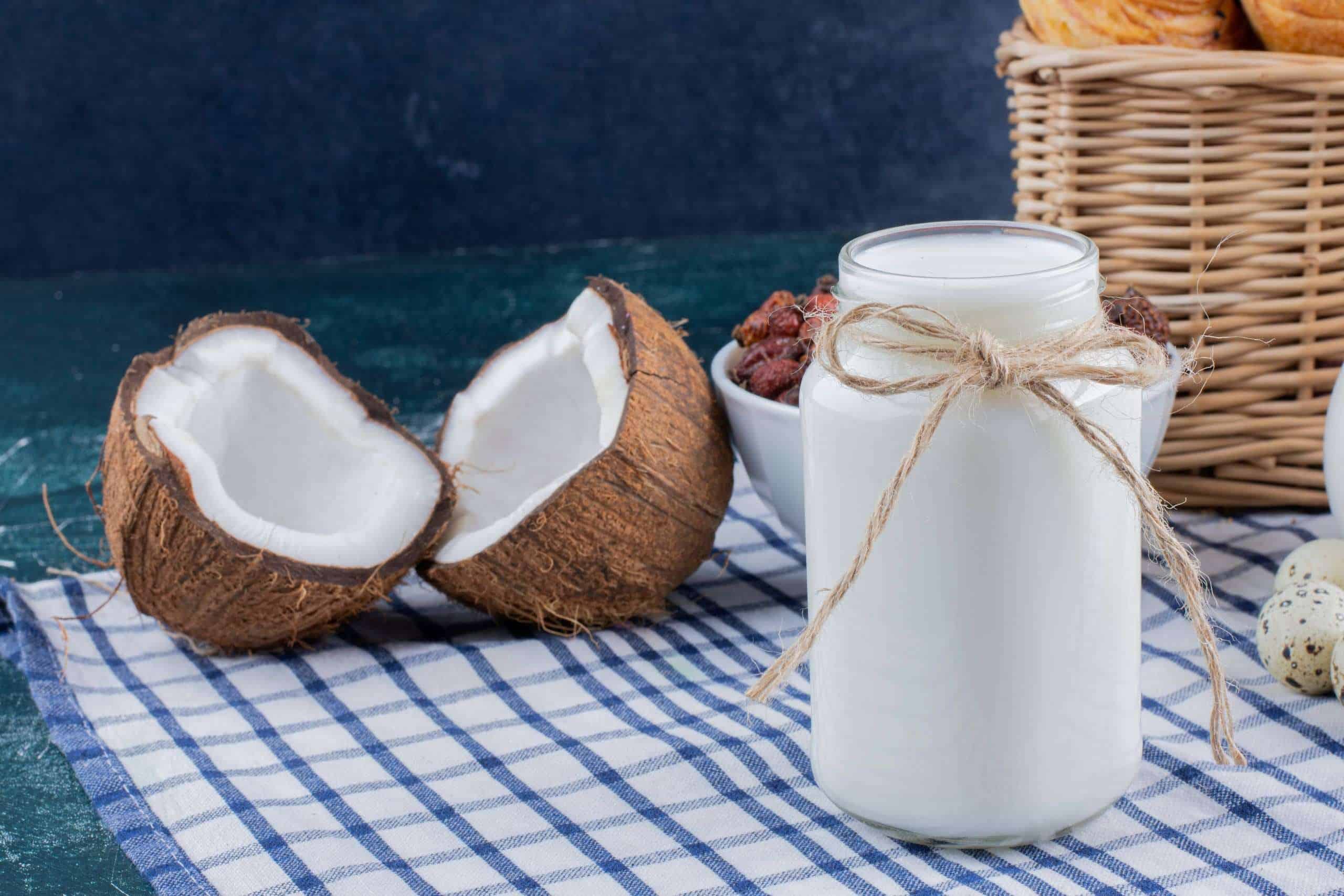 glass-jar-milk-half-cut-coconuts-marble-table